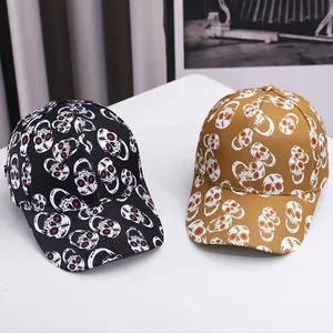 Detail showing Halloween baseball caps in black and yellow with red-eyed skull print