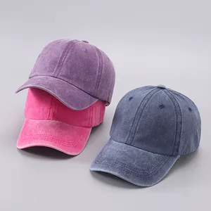 Detailed stack of three washed cotton baseball caps in vintage purple, pink and blue colors