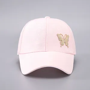Close-up of pink jacquard baseball cap with a sparkling rhinestone butterfly ornament