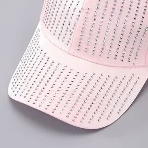 Detailed view of pink baseball cap with sparkling silver rhinestone fringe on brim