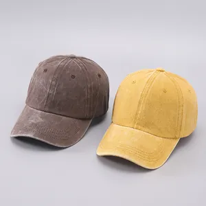 Detail of washed cotton baseball caps in brown and ginger showing corduroy-like texture
