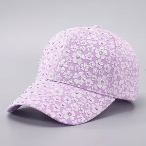 Close-up of lavender lace baseball cap with sparkling rhinestones and floral pattern