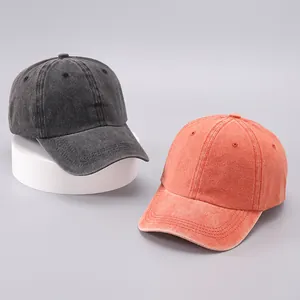 Detail of dark grey and orange washed cotton baseball caps with retro vintage texture
