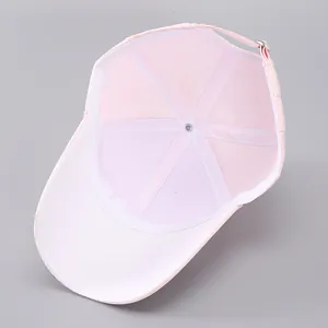 Detail of pink baseball cap showing breathable mesh, inner seams and adjustable metal buckle