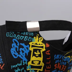 Macro detail of black baseball cap with colorful graffiti print and metal buckle
