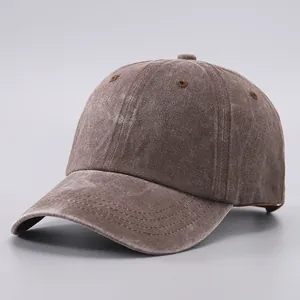 Detail of dark brown washed cotton baseball cap with vintage distressed texture
