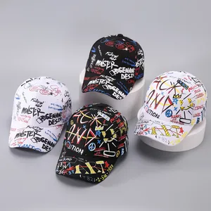 Close-up of baseball caps with street style graffiti prints and long ribbon details
