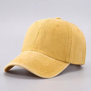 Close-up of yellow corduroy baseball cap showing fine texture and panel stitching