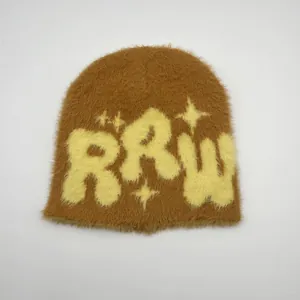 Close-up of brown faux mink fur beanie featuring yellow RRW letter and star embroidery
