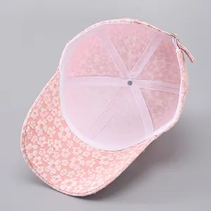 Detail of pink baseball cap showing interior lining, seams and adjustable metal buckle