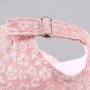 Detail of pink floral jacquard baseball cap with adjustable silver metal buckle strap