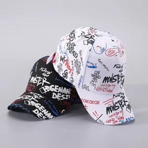 Detail of black and white baseball caps with dynamic street graffiti and ribbon accents