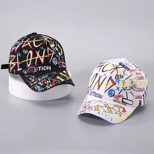 Detail of graffiti print baseball caps with ribbon accents in black and white styles
