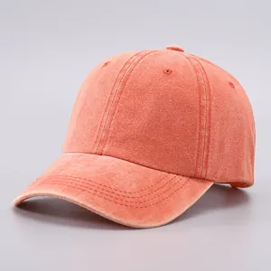 Adjustable washed cotton baseball cap in vibrant coral orange with a classic soft top design