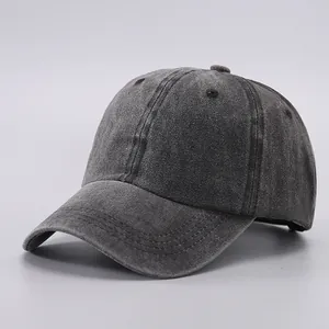 Detail view of washed cotton baseball cap showing vintage gray fabric and six-panel stitching