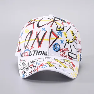 Detail of white baseball cap with colorful street art graffiti and long ribbon strap