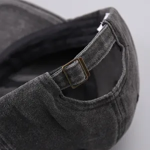 Detail of washed cotton baseball cap with adjustable vintage bronze metal buckle