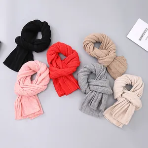 Three-piece knitted winter hat scarf and glove set with ribbed texture and pompom