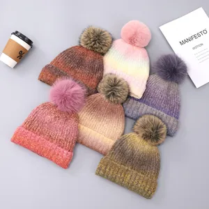 Set of six gradient tie-dye knit beanies with fluffy faux fur pom poms and thick texture