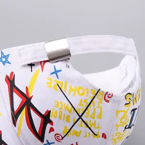 Macro detail of the white baseball cap with colorful graffiti print and metal buckle