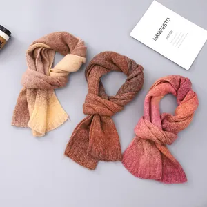 Three tie-dye knitted scarves in gradient autumn tones with warm winter texture