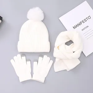 Winter set with white knit hat, pom-pom, scarf, and touch screen gloves for kids