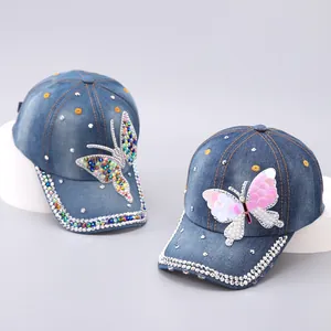 Detail of denim baseball caps with colorful rhinestones and sequin butterfly patches
