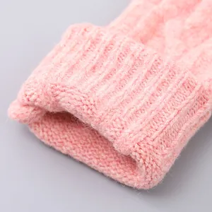 Detailed close-up of pink knit scarf showing thick cable knit texture and ribbed edge