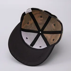 Detail of snapback hat showing 100% polyester label and camo print lining inside