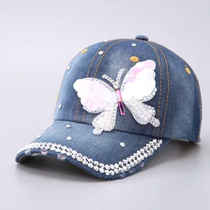 Detailed view of denim baseball cap with butterfly sequin patch and crystal rhinestones