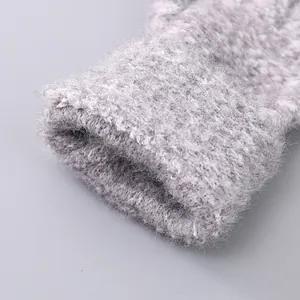 Close-up of thick ribbed cuffs on grey knit gloves with warm plush texture details