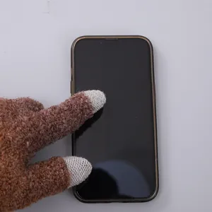 Detail of knitted touchscreen gloves with conductive fingertips for winter warmth