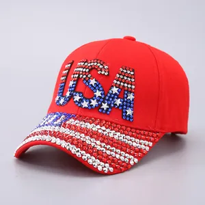 Detailed view of red USA baseball cap with rhinestone American flag patterns and lettering