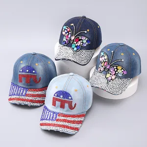 Detail view of four denim baseball caps featuring crystal butterfly and elephant designs