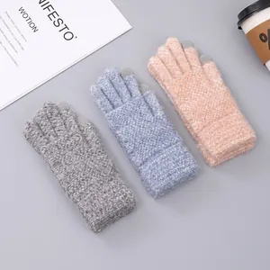Close-up of winter knit gloves with touchscreen fingers in gray, blue and pink