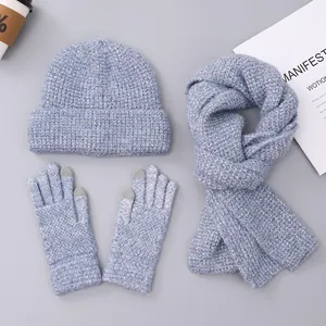 Detail of light blue knit winter set including touch screen gloves, scarf and warm hat