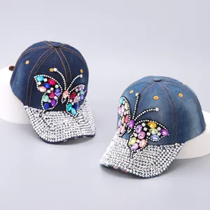 Detail of colorful butterfly rhinestones and sparkling crystals on denim baseball cap
