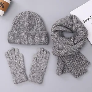 Detailed knit texture of gray winter set including beanie, scarf, and touchscreen gloves