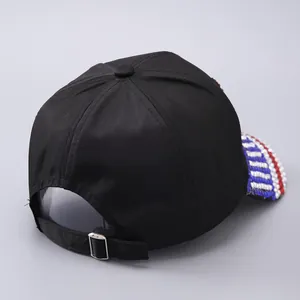 Detail of adjustable metal buckle and tricolor beaded trim on black USA baseball cap