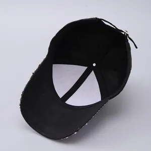 Detail of USA baseball cap with rhinestone brim, mesh back, and adjustable strap