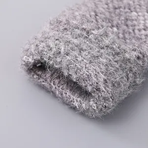 Close-up of thick grey mixed-knit fabric detail with soft texture for winter warmth