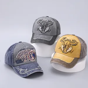 Detail of vintage washed cotton baseball caps with animal embroidery and frayed denim patches