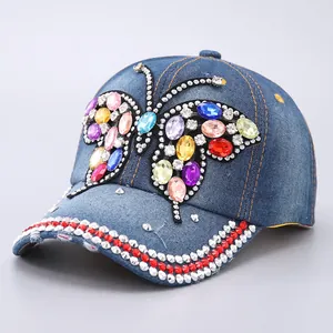 Blue denim baseball cap with colorful rhinestone butterfly and crystal brim embellishment