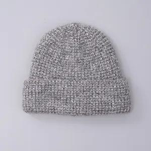 Close-up of grey knit beanie texture featuring soft wool blend fibers and folded cuff