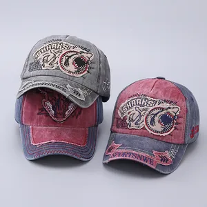 Detail of vintage washed cotton baseball cap with shark embroidery and distressed brim