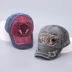 Detail of vintage washed cotton baseball caps with bull and shark embroidery patches