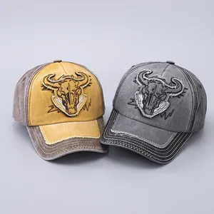 Detail of vintage washed cotton baseball caps with embroidered bull skull patches