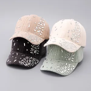 Detailed view of four colors of corduroy baseball caps with sparkling rhinestone accents