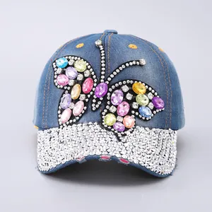 Detailed view of luxury butterfly denim cap with colorful rhinestones and shiny crystals