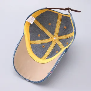 Detail of denim baseball cap interior with 100% cotton lining and pearl leather strap